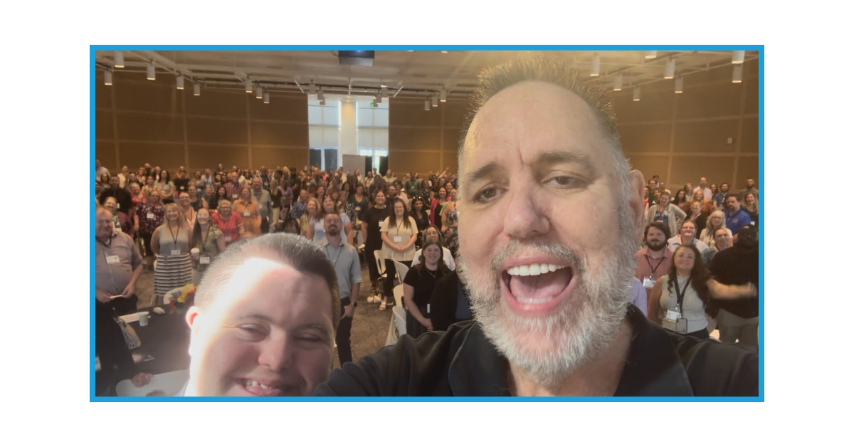A photo of John and Mark Cronin with the audience at the Western Partnership Conference.