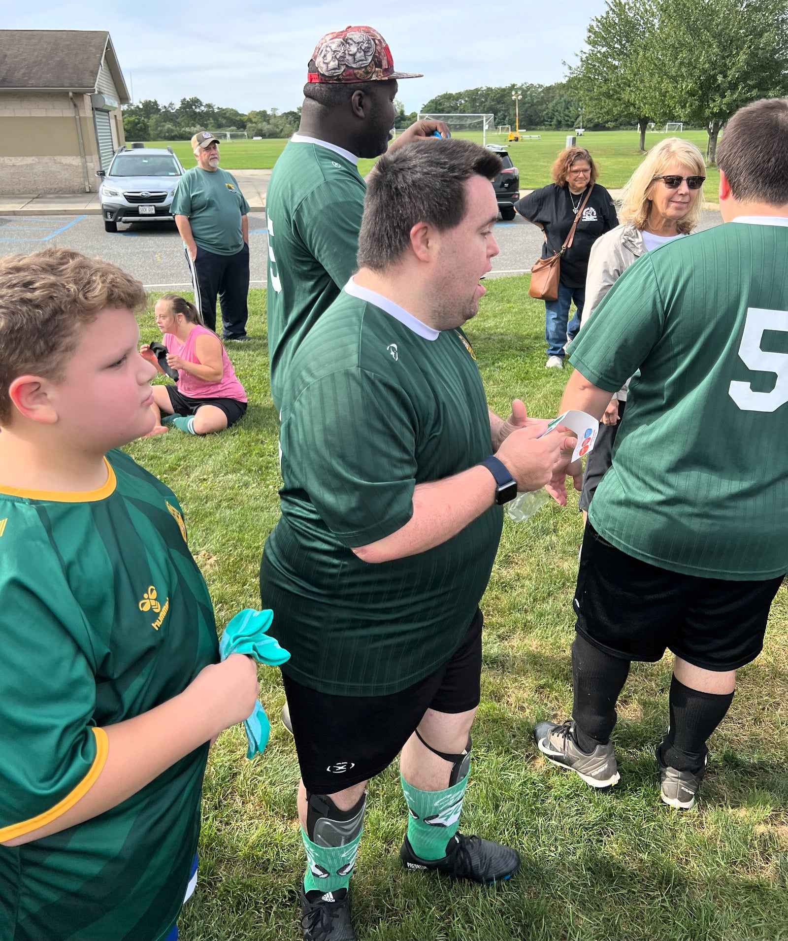 John Gives Athletic Socks to His Special Olympic Soccer Teammates