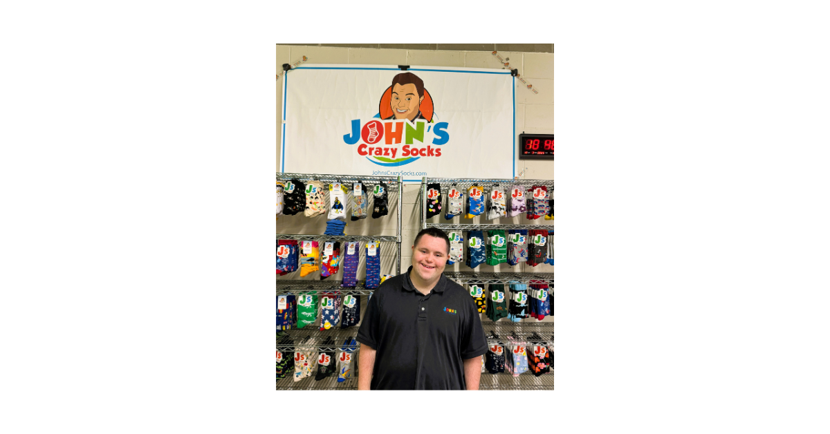 John Cronin at the JCS warehouse with a lot of socks in the background.