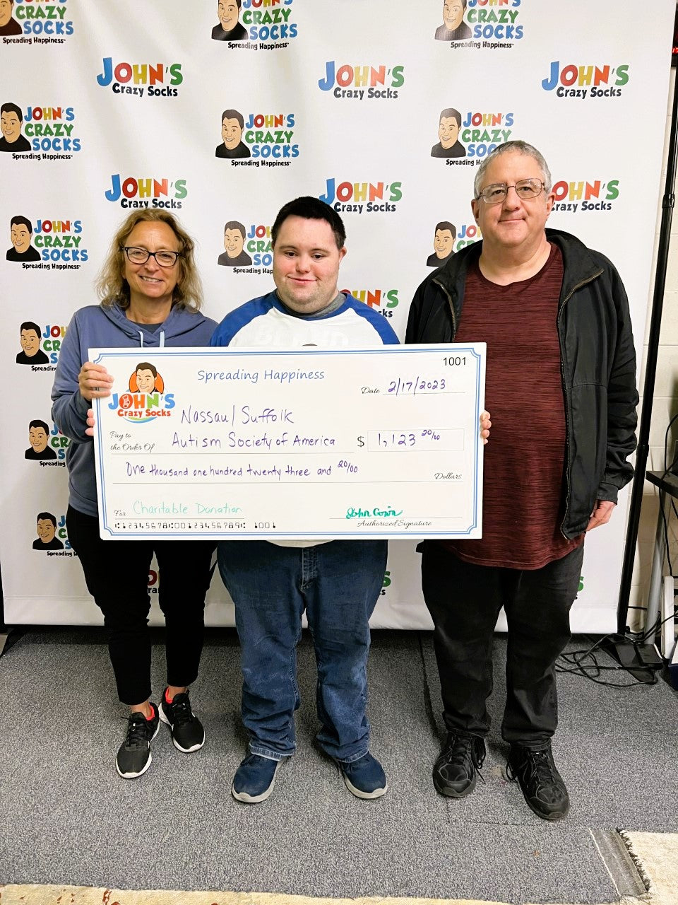 John’s Crazy Socks Presents a Donation Check to the Autism Society of America