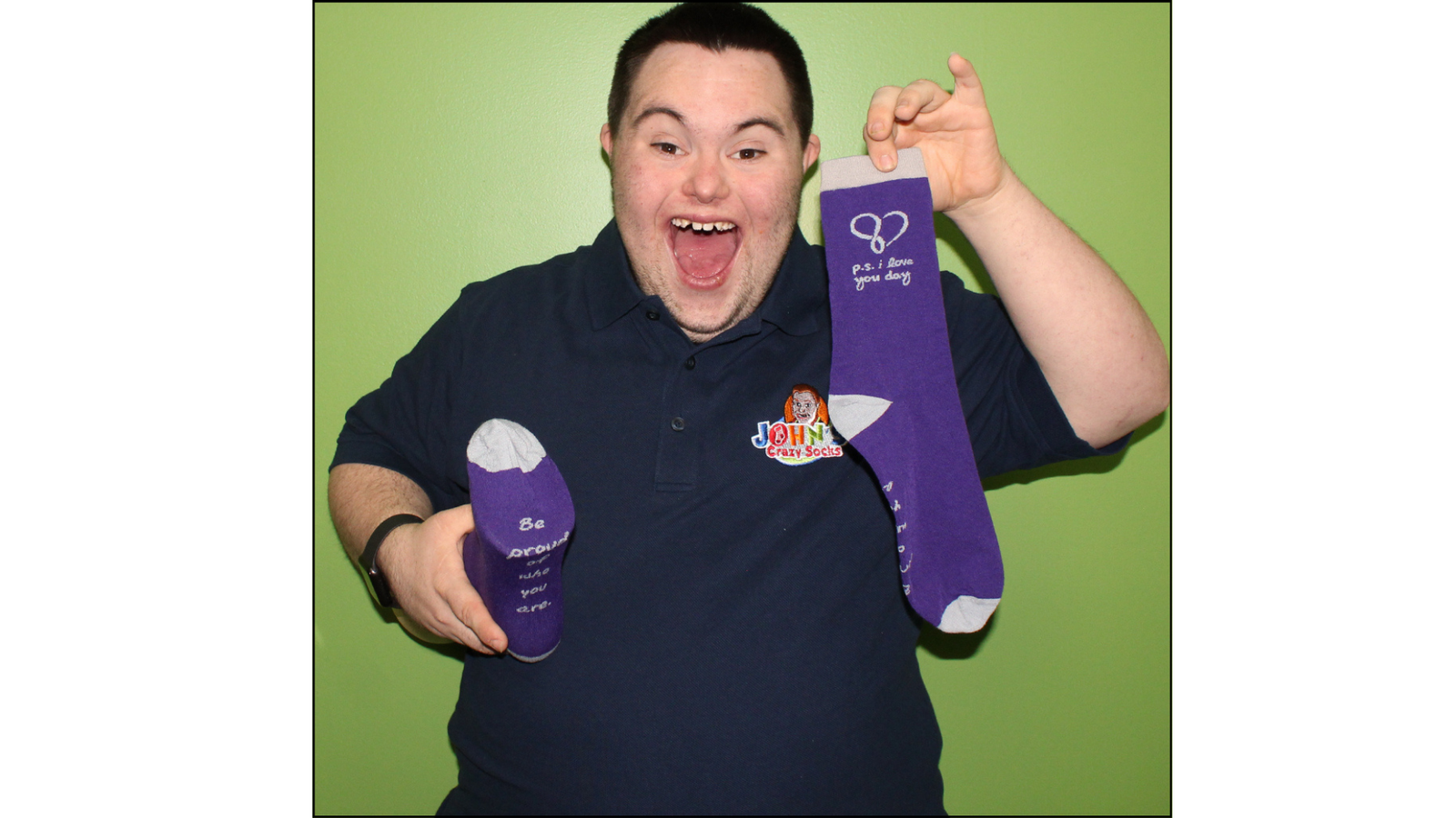 An image of John Cronin, co-founder of John's Crazy Socks holding the P.S. I Love You Day Crew Socks.