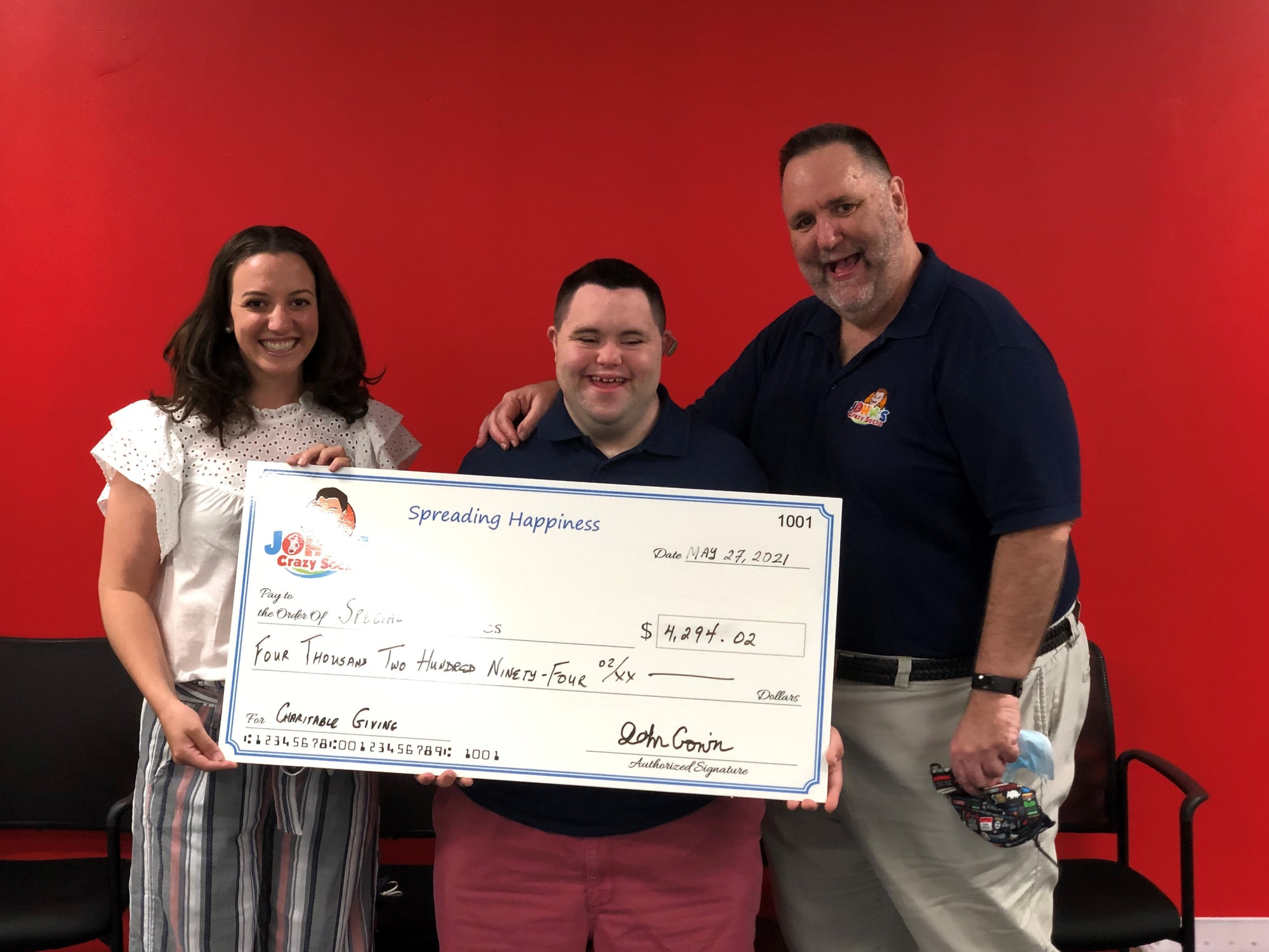 John of John's Crazy Socks Delivers a Donation Check to the Special Olympics