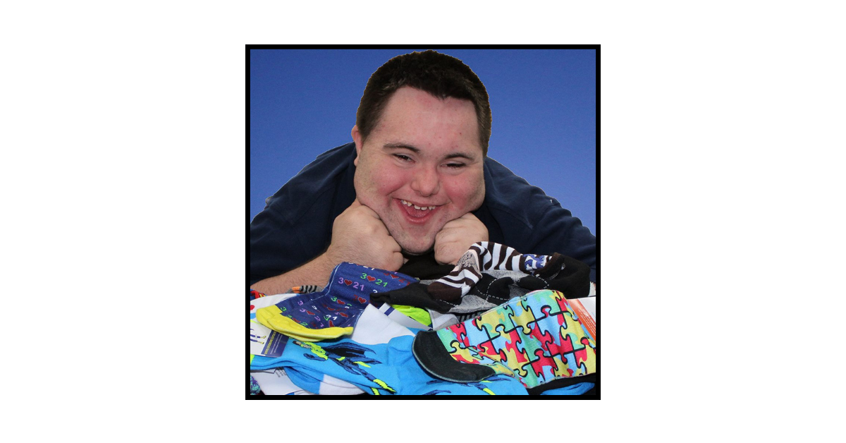 John Cronin, co-founder of John’s Crazy Socks, surrounded by his signature colorful socks.