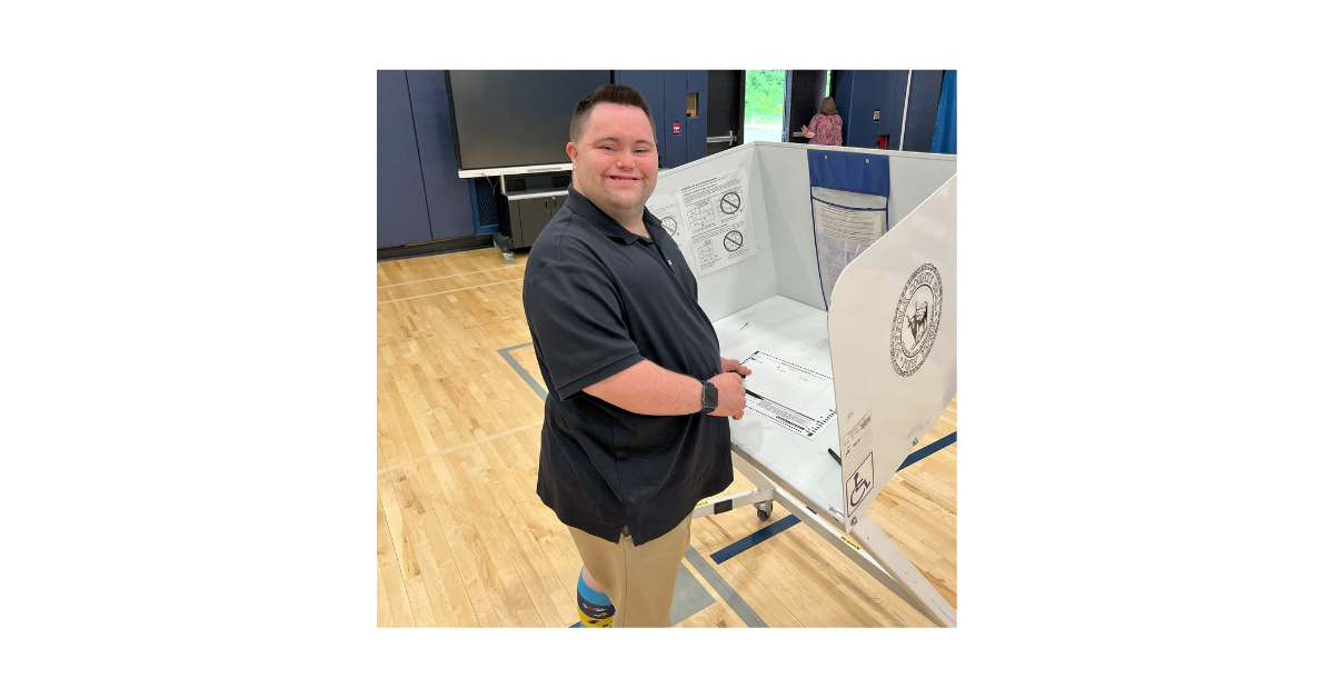 John casts his ballot at the polling station. 