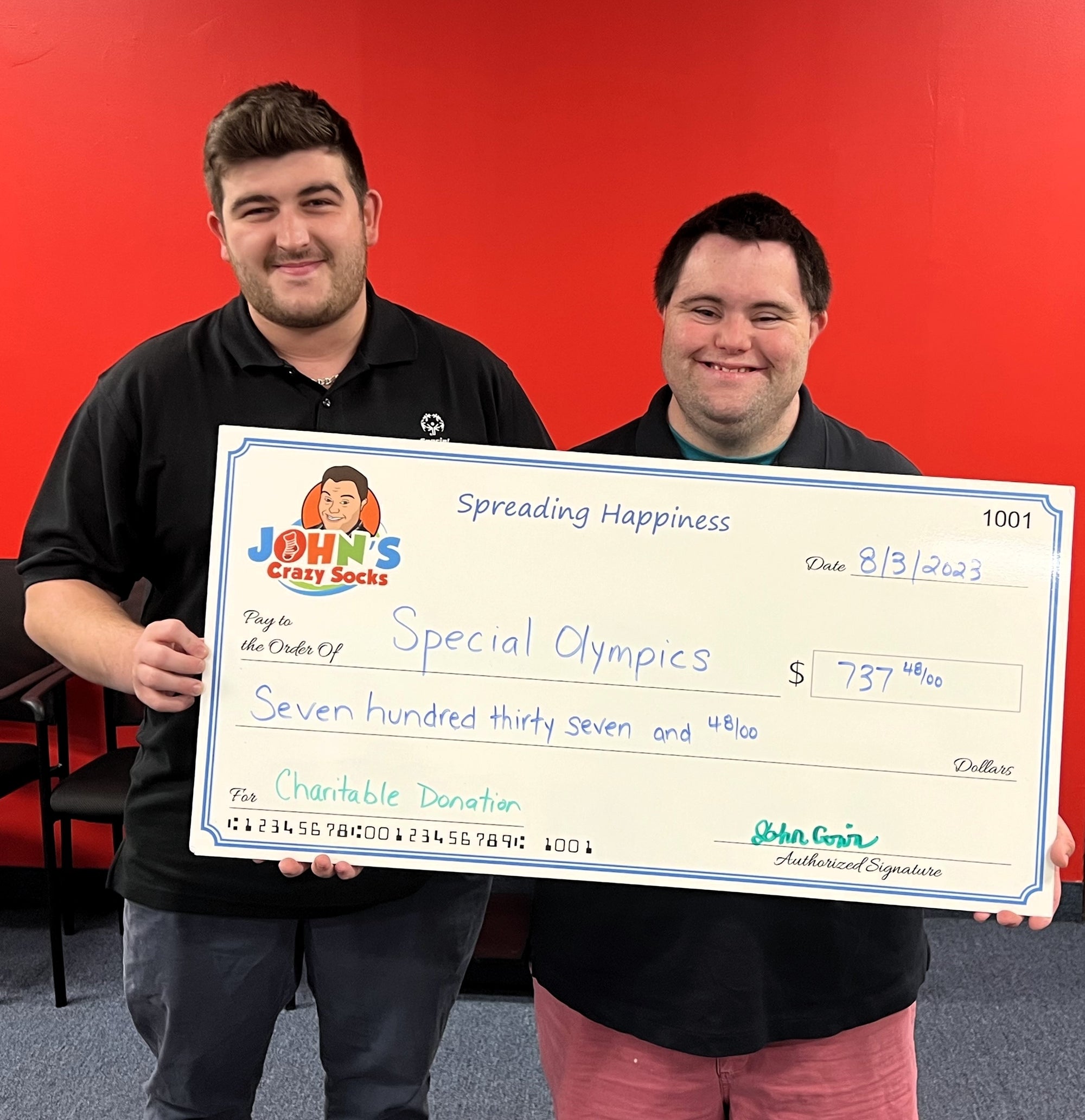 John’s Crazy Socks Delivers a Donation Check to the Special Olympics NY