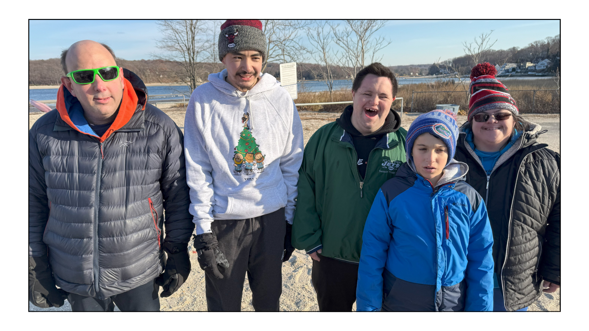 An image of John Cronin, co-founder of John's Crazy Socks, and his Huntington Blue Devil teammates on the beach.