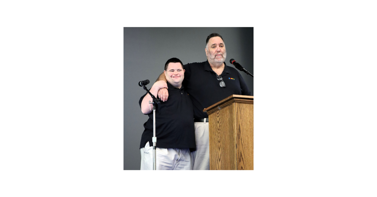 An image of John and Mark Cronin on stage during a speaking engagement. 